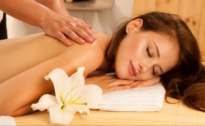 Body care. Spa body massage treatment. Woman having massage in the spa salon